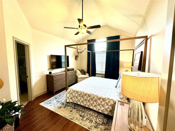 a bedroom with a bed and flat screen tv