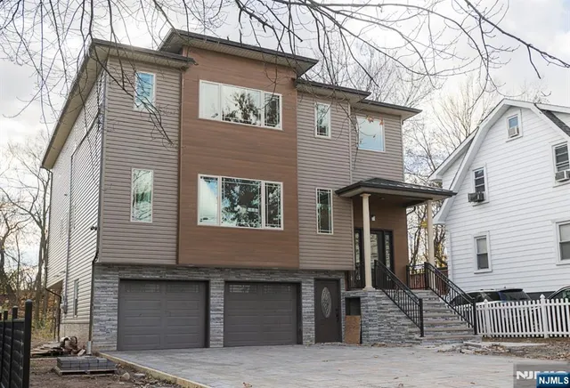 a living room with furniture kitchen and a flat screen tv
