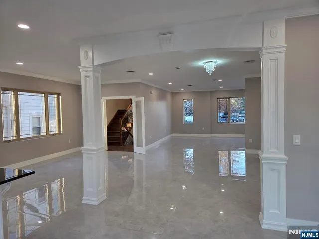 a view of kitchen with kitchen island and windows