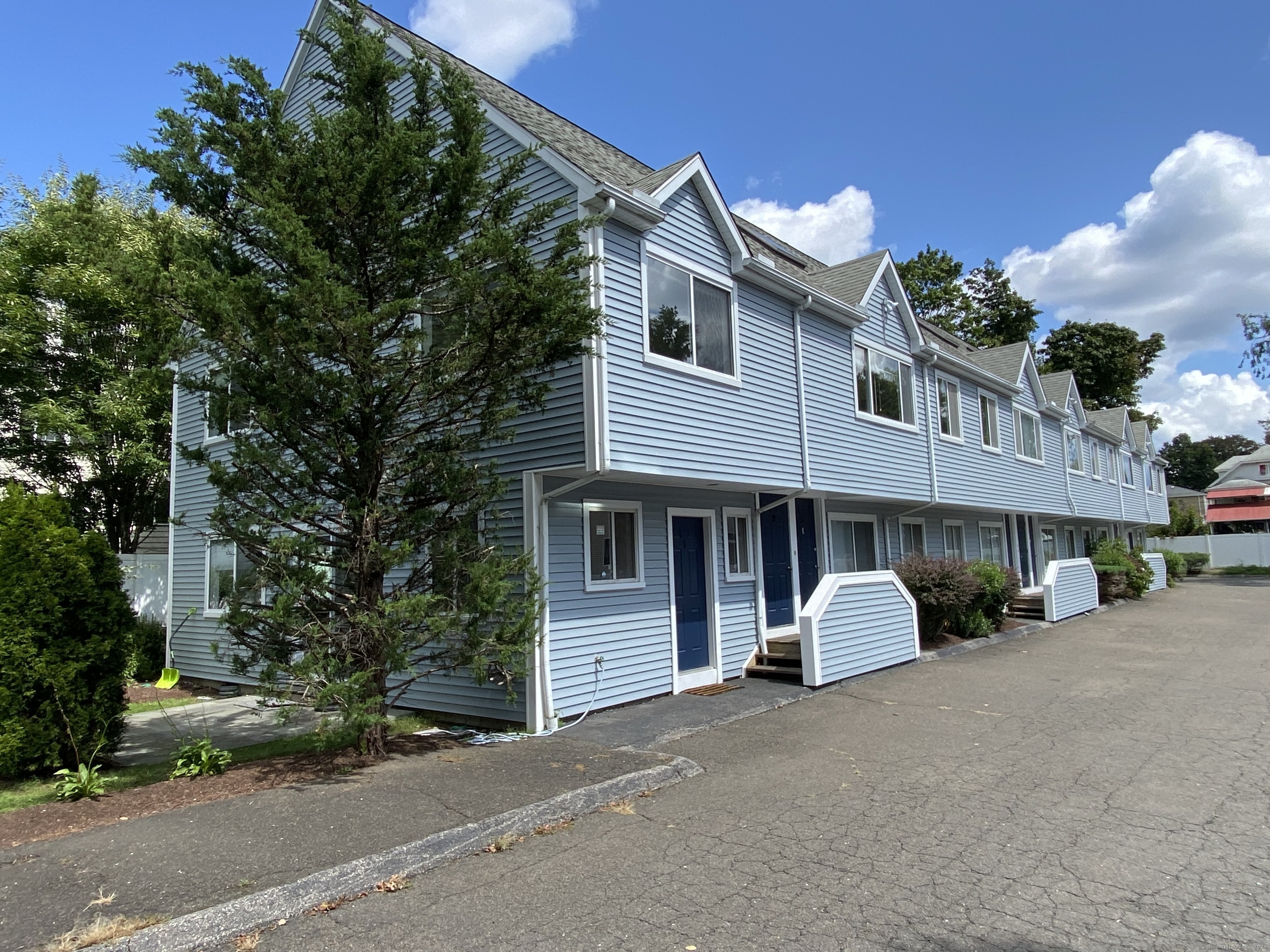 34 Stuart Avenue, Unit 1 Norwalk, CT 06850 - Photo 1 of 1 a front view of a house with a garden and parking