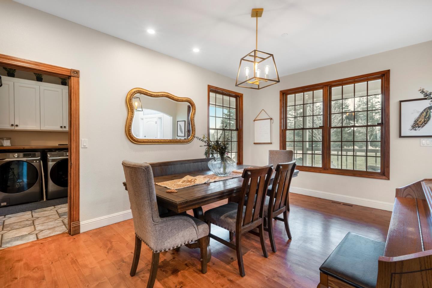 2760 Leavesley Road Gilroy, CA 95020 - Photo 13 of 77 a dining room with wooden floor a chandelier a glass table and chairs