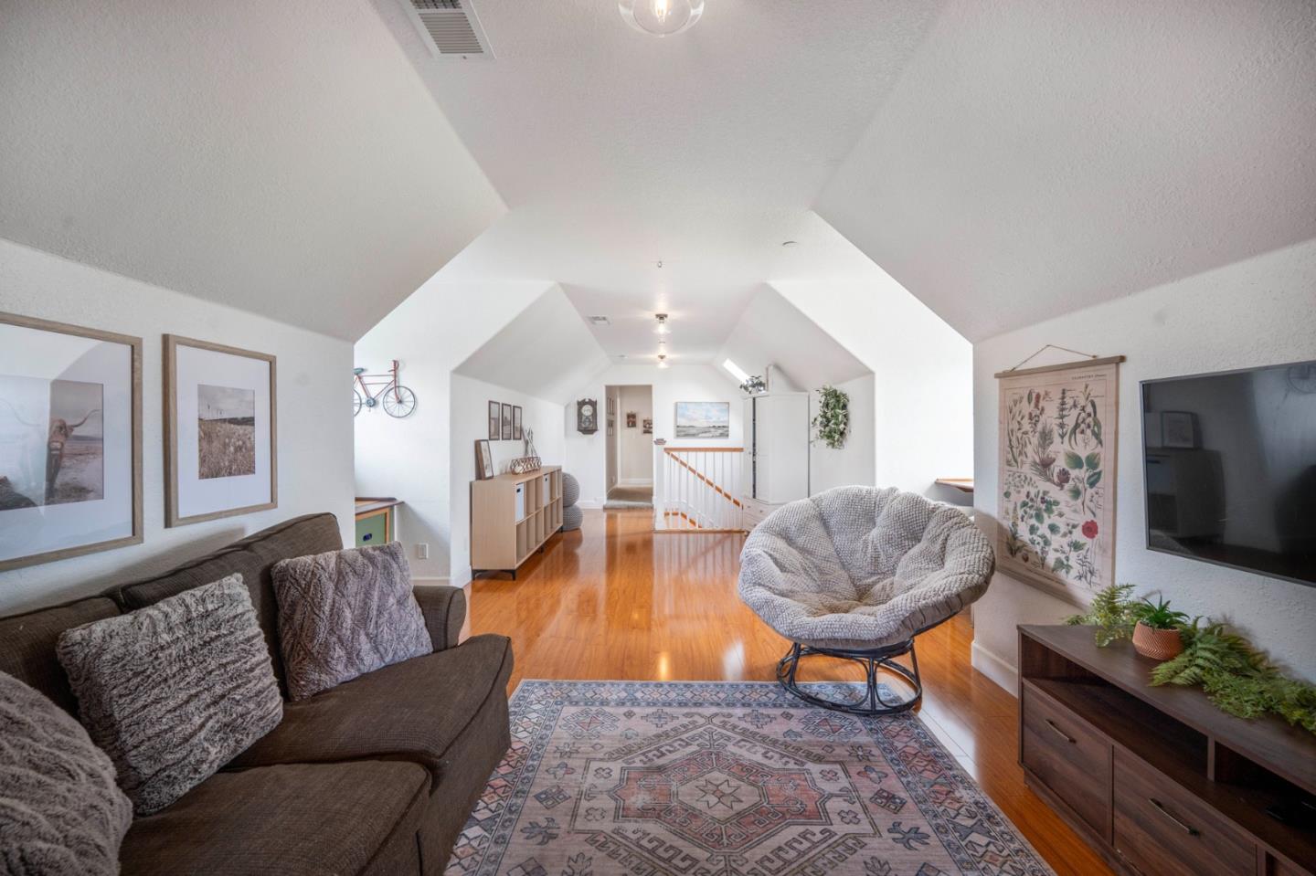 2760 Leavesley Road Gilroy, CA 95020 - Photo 47 of 77 a living room with furniture a flat screen tv and a dining table with wooden floor