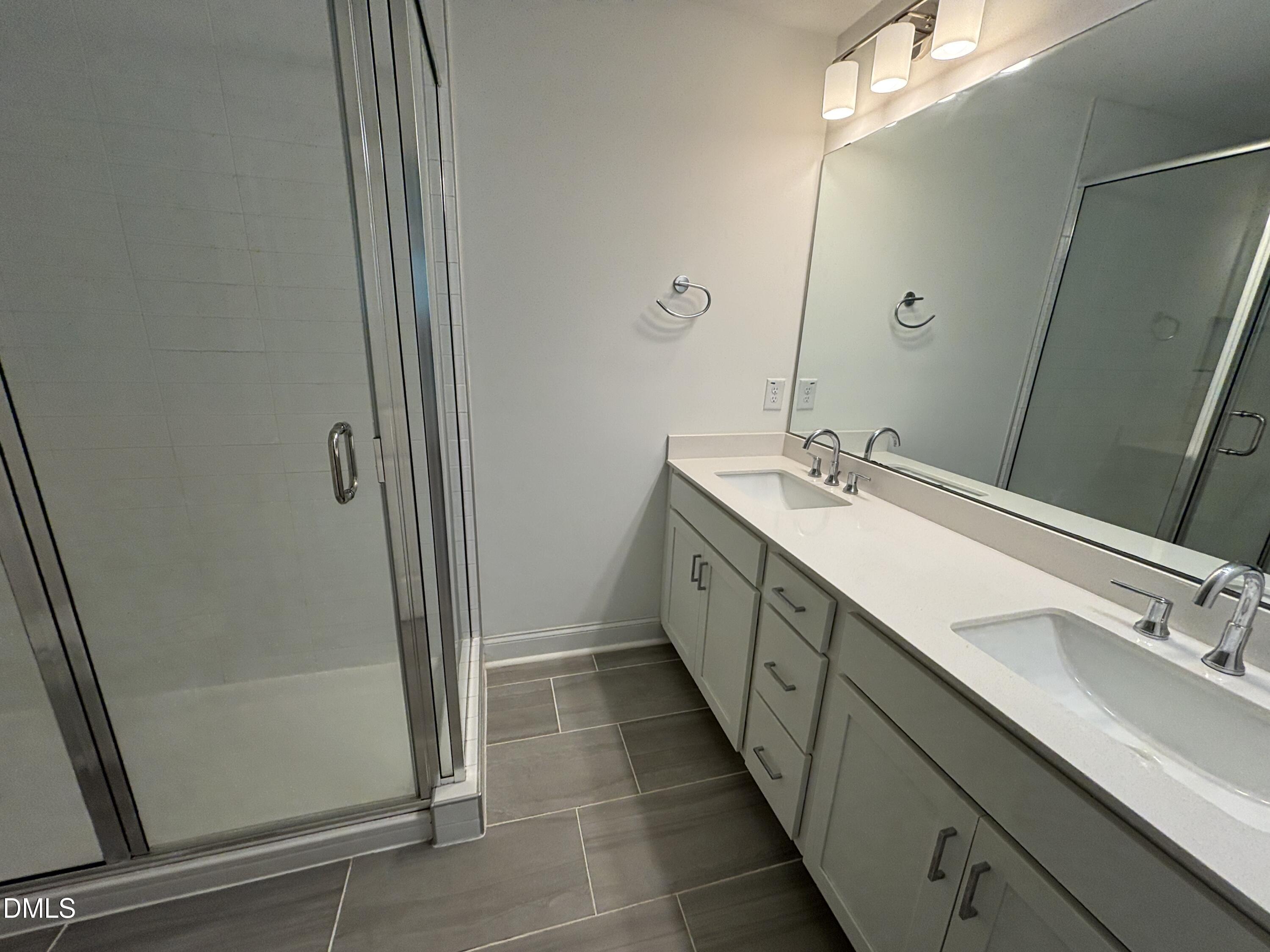 5710 Parker Pnes Court Raleigh, NC 27609 - Photo 48 of 78 a bathroom with a double vanity sink and a mirror