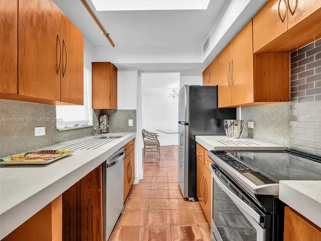 a living room with furniture a flat screen tv and a table