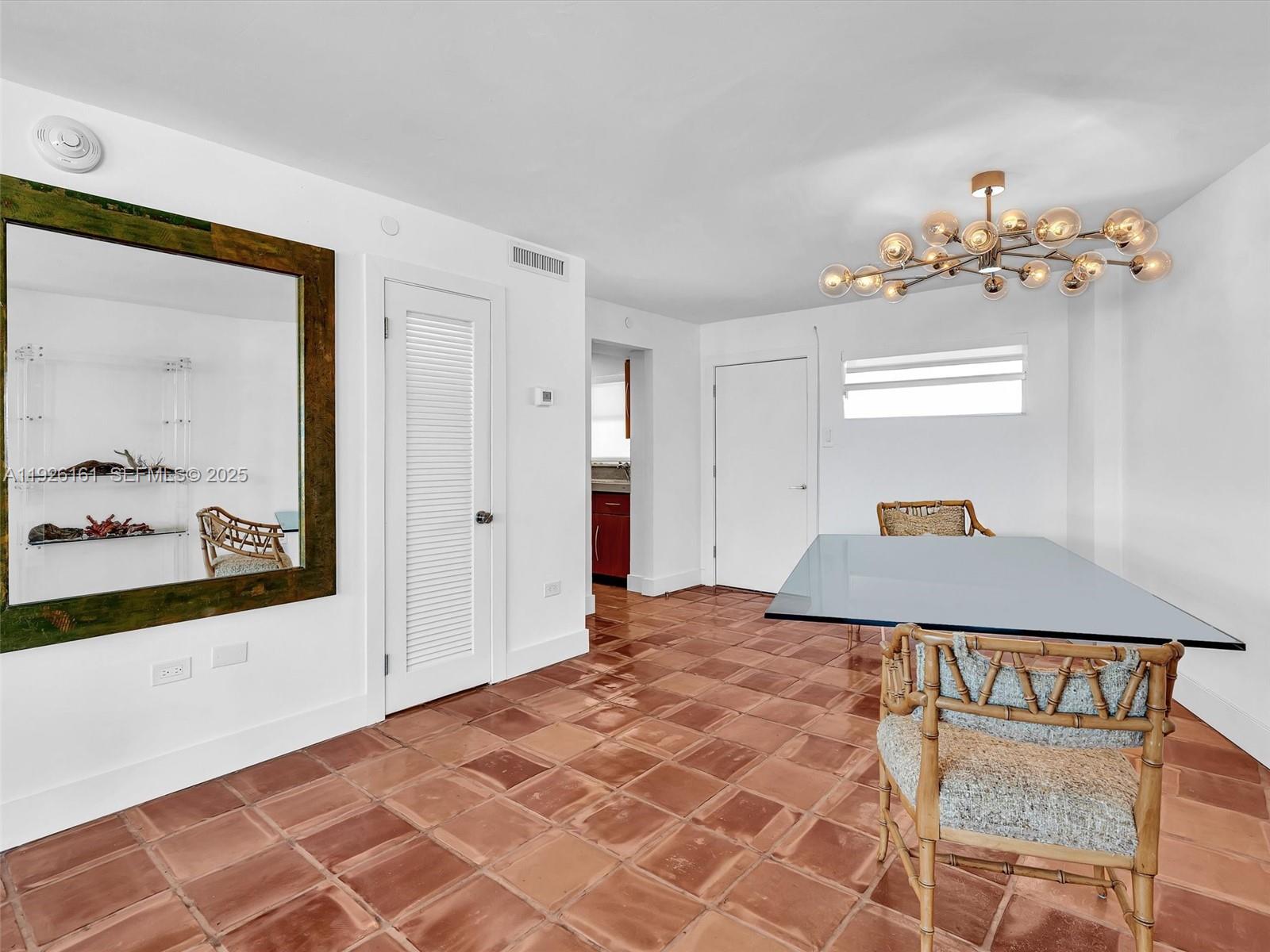 1881 Washington Avenue, Unit 16E Miami Beach, FL 33139 - Photo 16 of 65 a bedroom with a bed and a painting on the wall