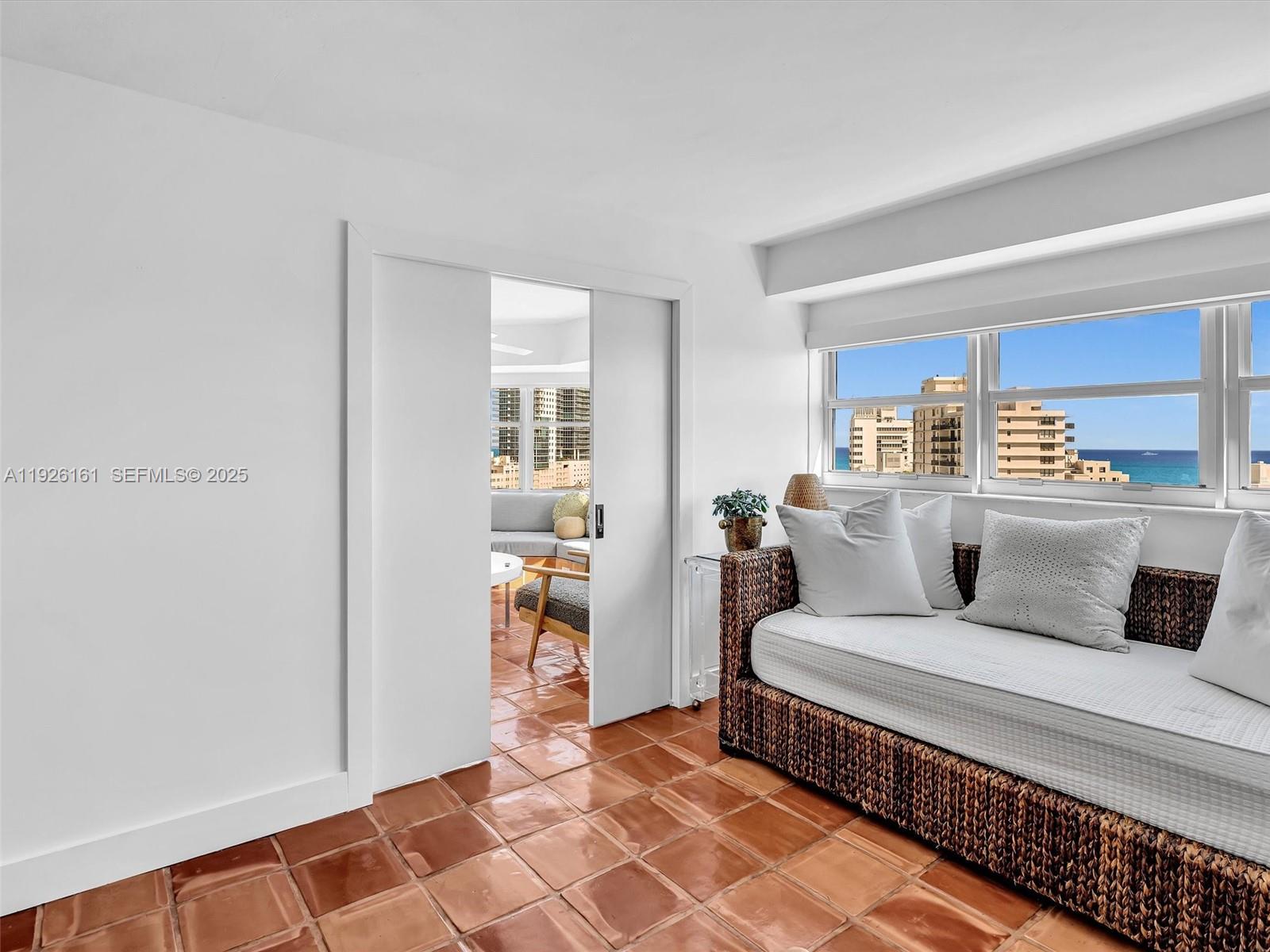1881 Washington Avenue, Unit 16E Miami Beach, FL 33139 - Photo 20 of 65 a living room with a couch and a window