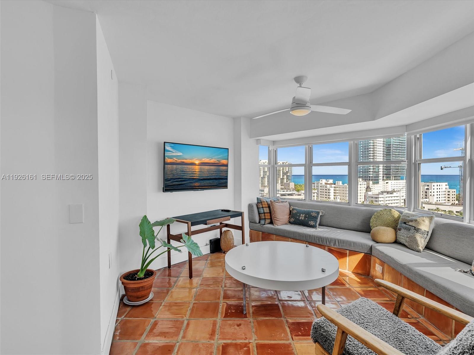 1881 Washington Avenue, Unit 16E Miami Beach, FL 33139 - Photo 23 of 65 a living room with furniture a flat screen tv and a table