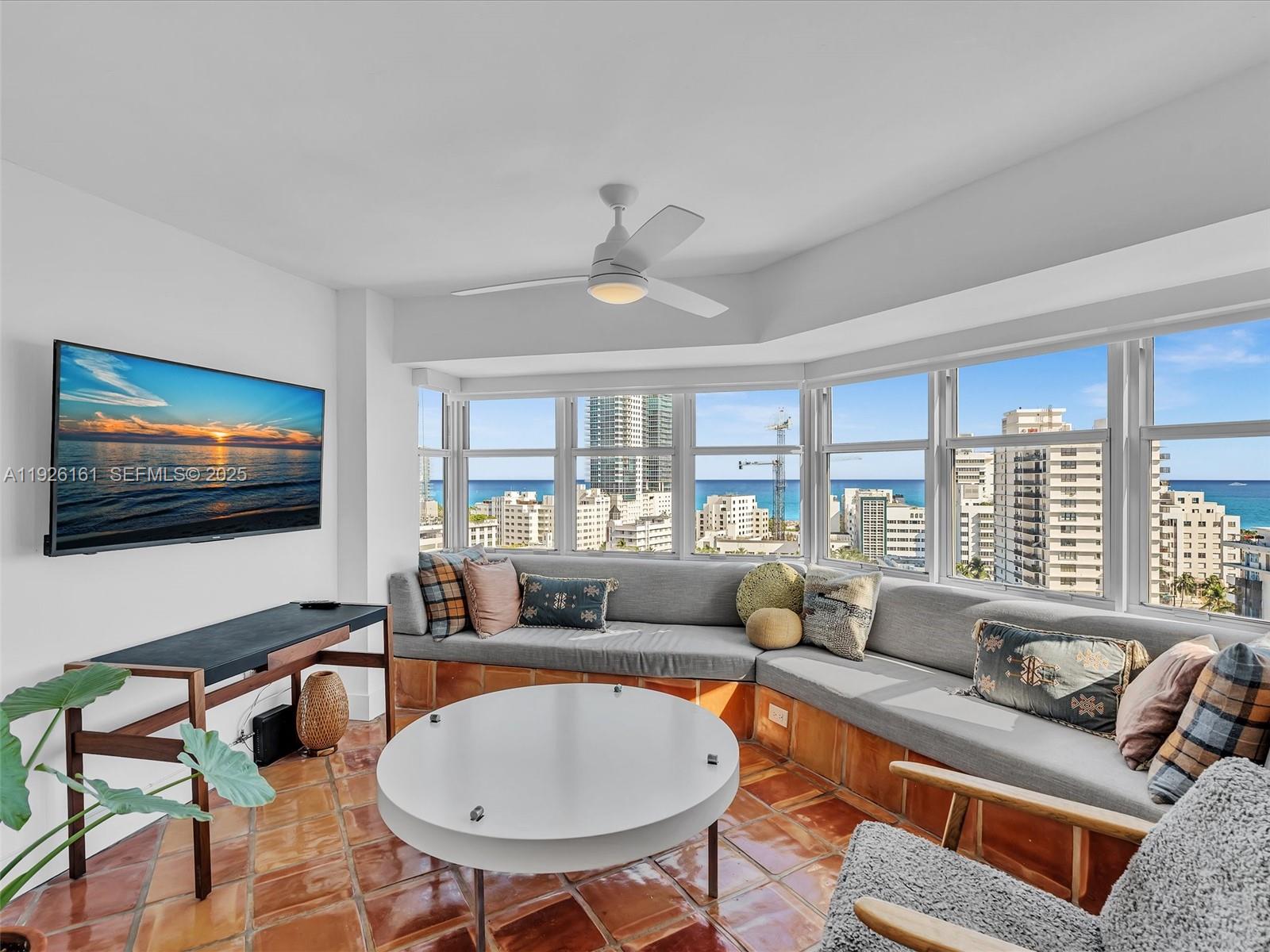 1881 Washington Avenue, Unit 16E Miami Beach, FL 33139 - Photo 24 of 65 a living room with furniture and a flat screen tv