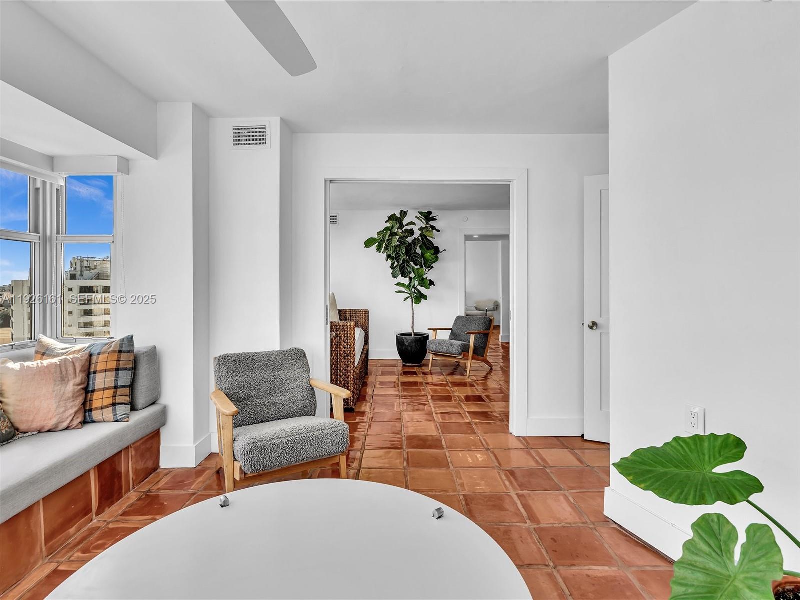 1881 Washington Avenue, Unit 16E Miami Beach, FL 33139 - Photo 27 of 65 a living room with furniture and a potted plant