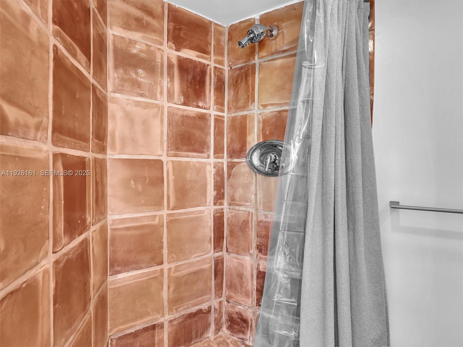 1881 Washington Avenue, Unit 16E Miami Beach, FL 33139 - Photo 29 of 65 a bathroom with a shower and a glass door