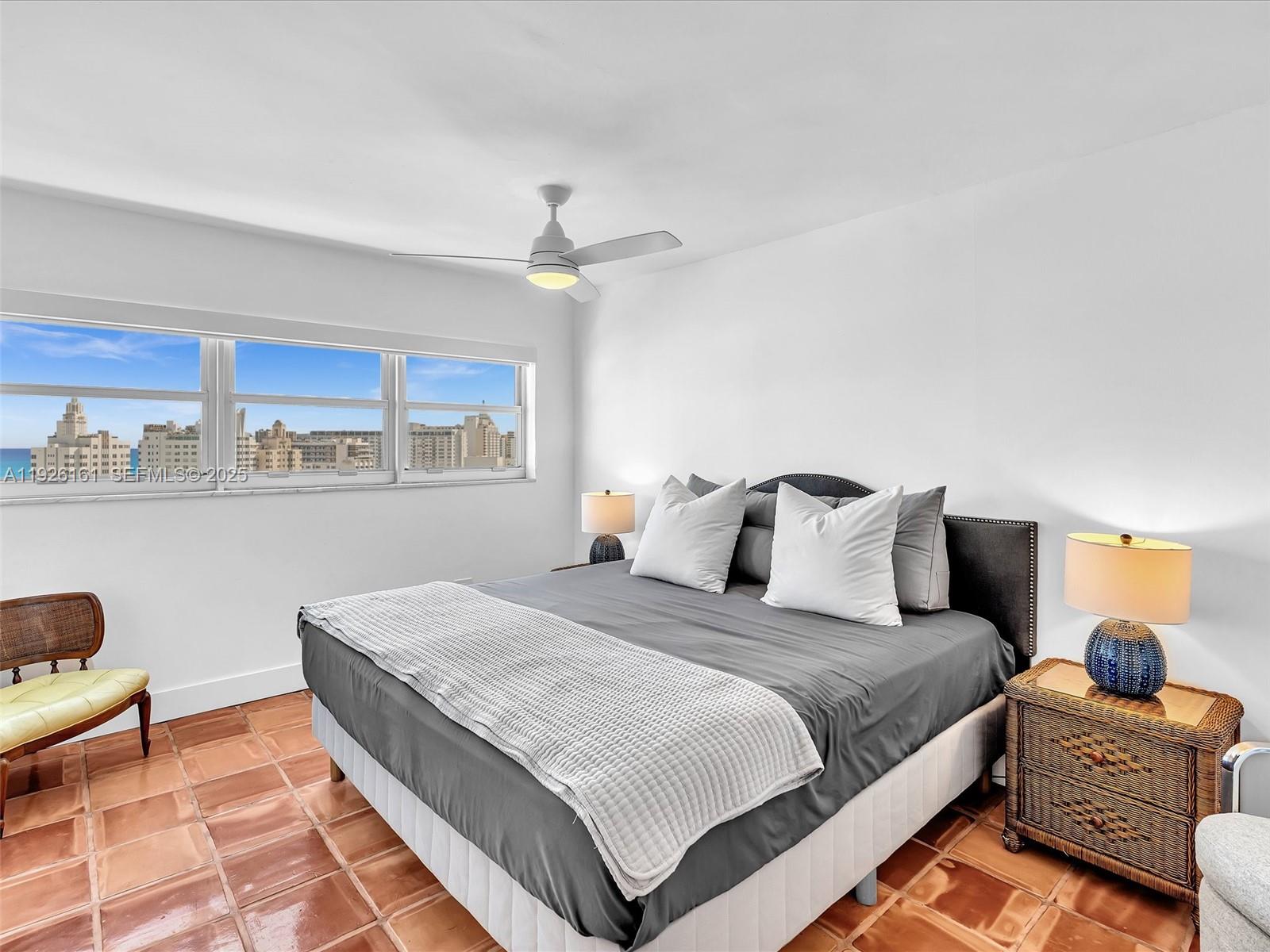 1881 Washington Avenue, Unit 16E Miami Beach, FL 33139 - Photo 36 of 65 a bedroom with a large bed and a chandelier