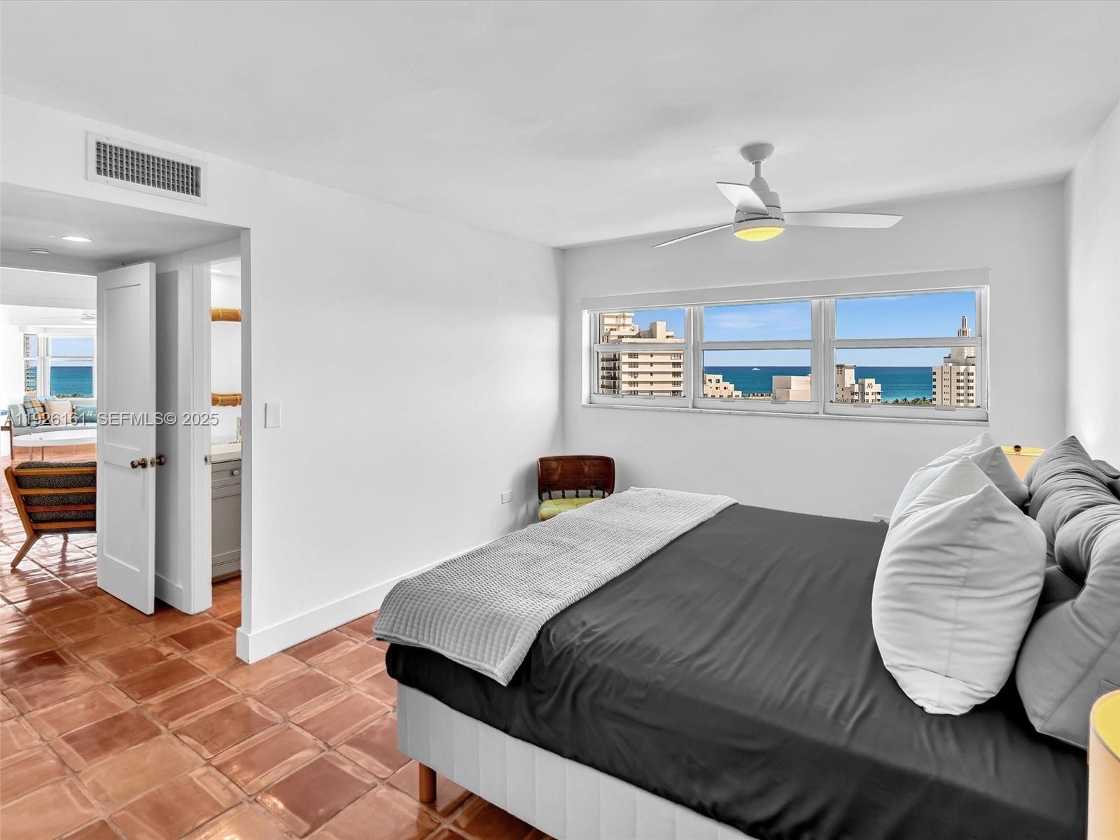 1881 Washington Avenue, Unit 16E Miami Beach, FL 33139 - Photo 43 of 65 a bedroom with a bed and a chandelier