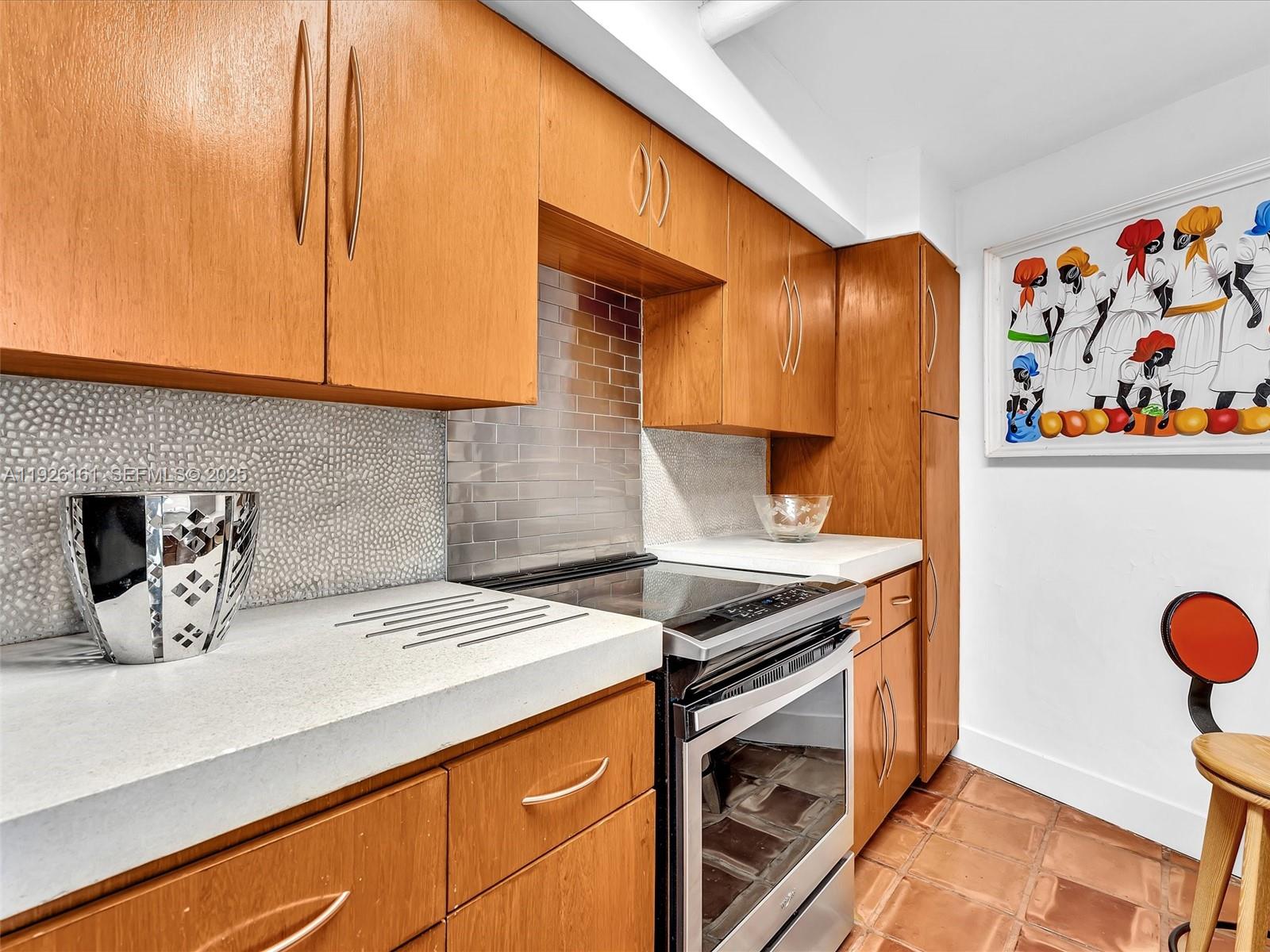 1881 Washington Avenue, Unit 16E Miami Beach, FL 33139 - Photo 10 of 65 a kitchen with a sink and a stove top oven