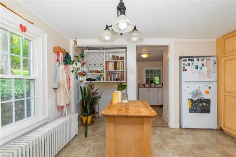 a view of a hallway with furniture and a chandelier