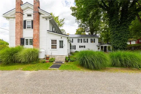 a view of a house with a yard and plants