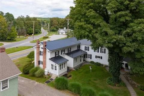 an aerial view of a house with a big yard