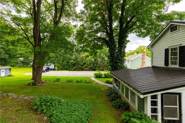 a view of house with a backyard