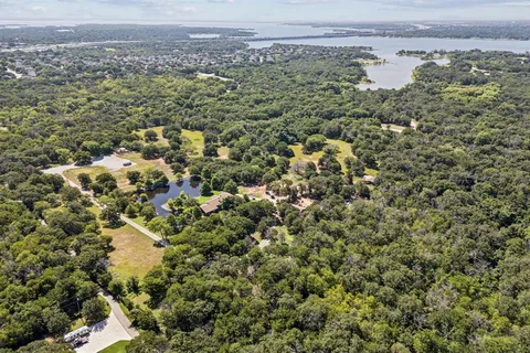 an aerial view of a residential houses with city view