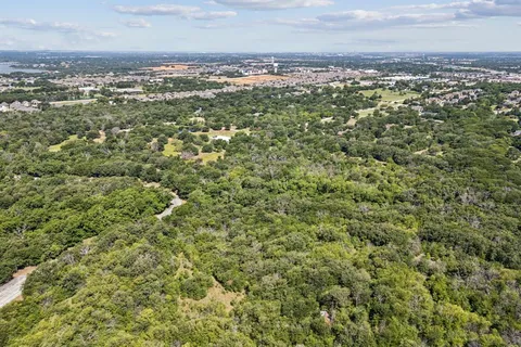a view of a field with a city view