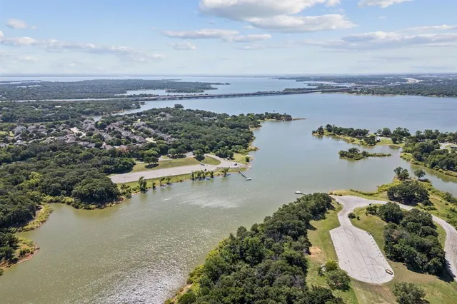 an aerial view of ocean and residential houses with outdoor space