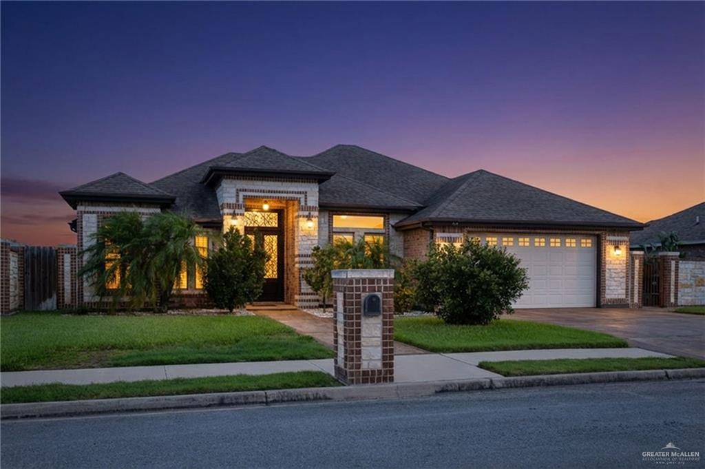704 Santa Fe Street Weslaco, TX 78596 - Photo 1 of 25 a front view of house with yard and green space