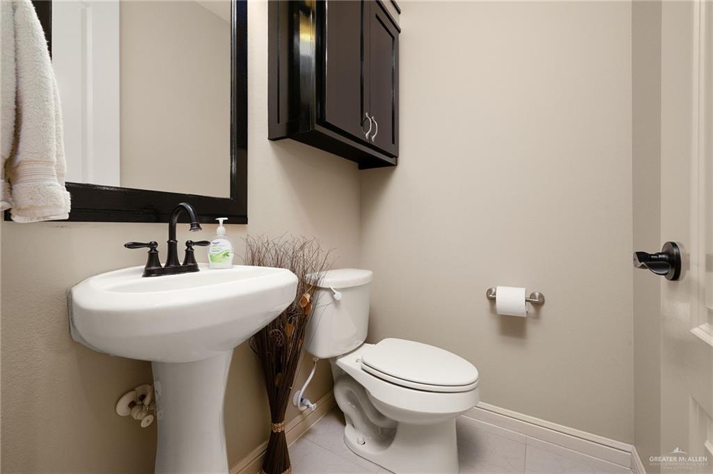704 Santa Fe Street Weslaco, TX 78596 - Photo 14 of 25 a bathroom with a sink toilet