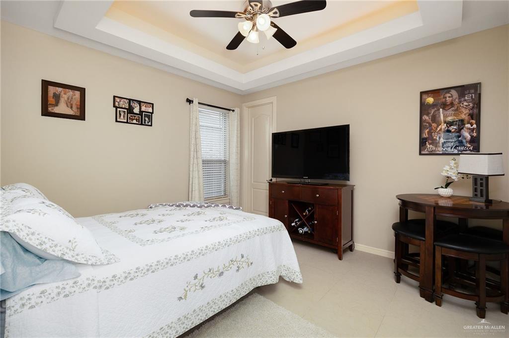 704 Santa Fe Street Weslaco, TX 78596 - Photo 18 of 25 a bedroom with a bed and a flat screen tv