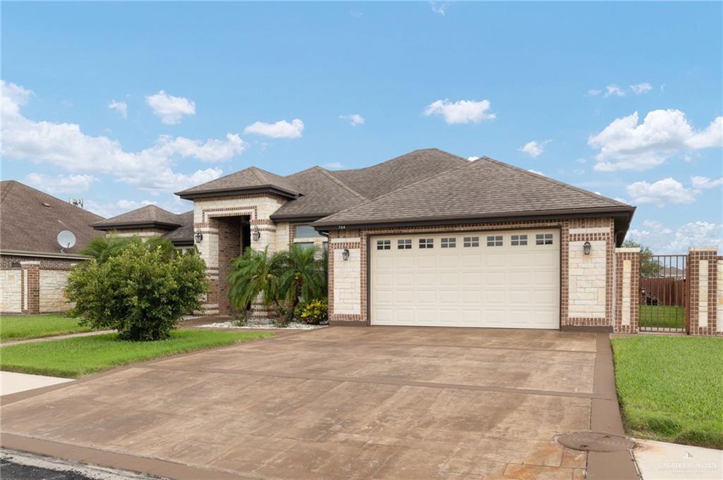 704 Santa Fe Street Weslaco, TX 78596 - Photo 4 of 25 a front view of house with yard and garage