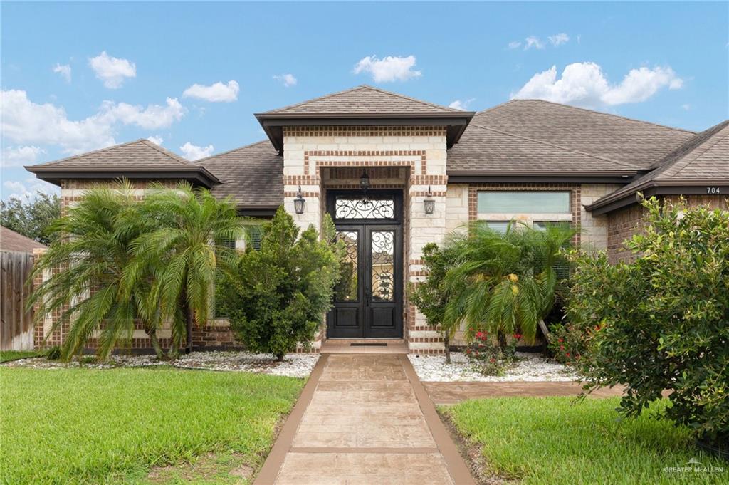 704 Santa Fe Street Weslaco, TX 78596 - Photo 5 of 25 a front view of a house with garden