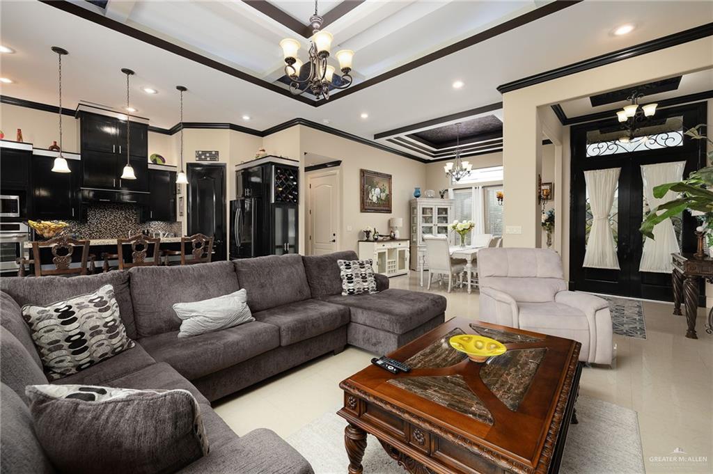 704 Santa Fe Street Weslaco, TX 78596 - Photo 8 of 25 a living room with furniture and a chandelier