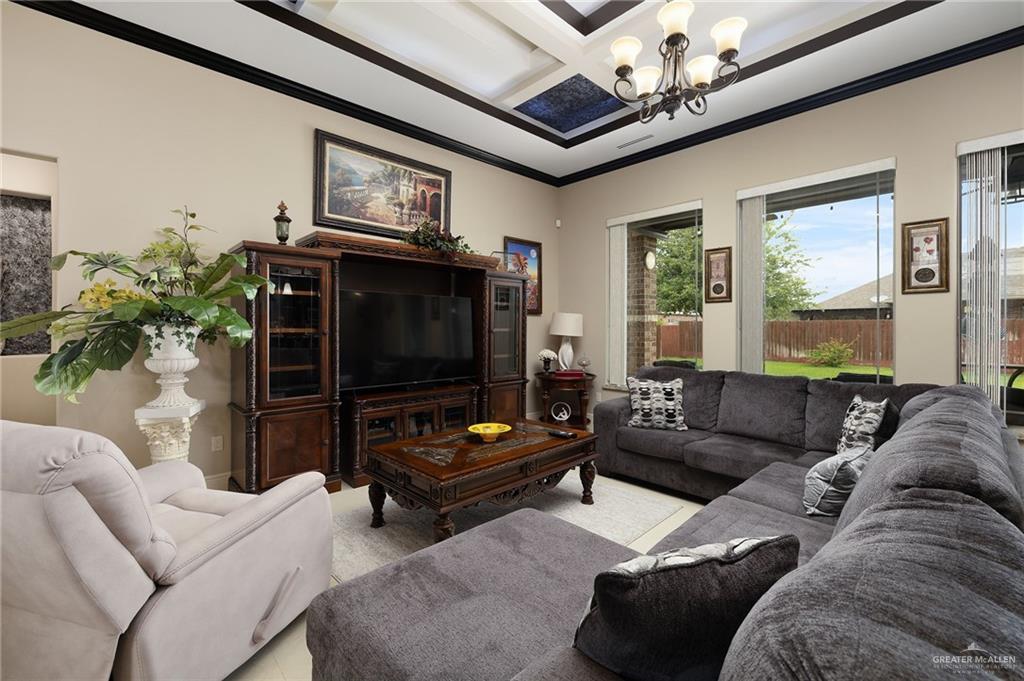 704 Santa Fe Street Weslaco, TX 78596 - Photo 9 of 25 a living room with furniture and a flat screen tv
