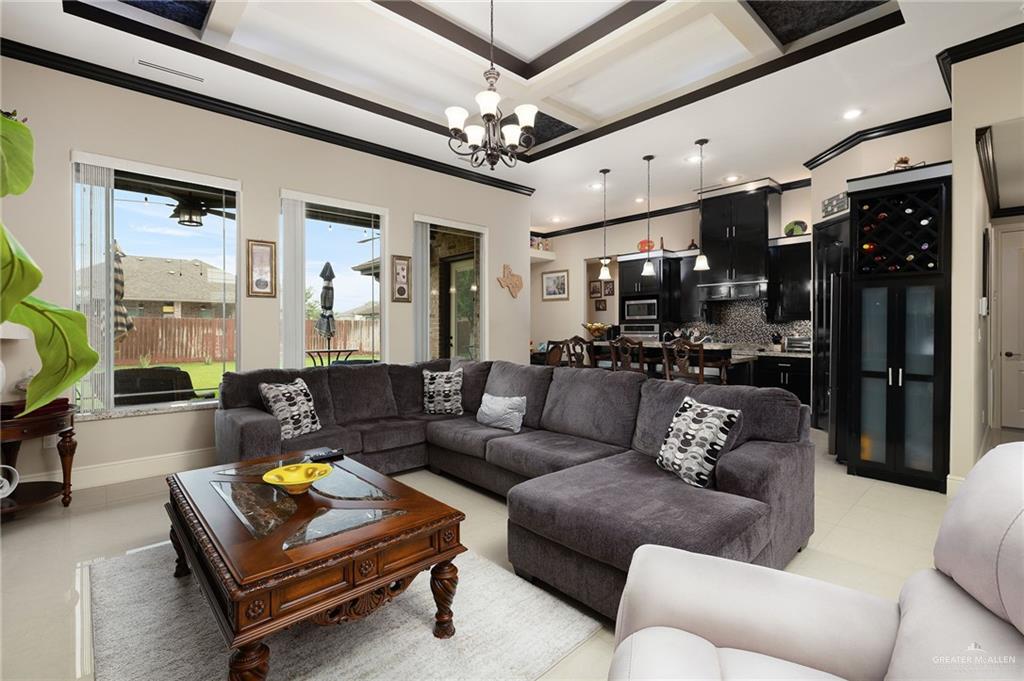 704 Santa Fe Street Weslaco, TX 78596 - Photo 10 of 25 a living room with furniture a ceiling fan and a rug