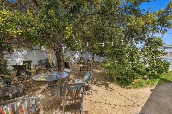 a view of a backyard with sitting area