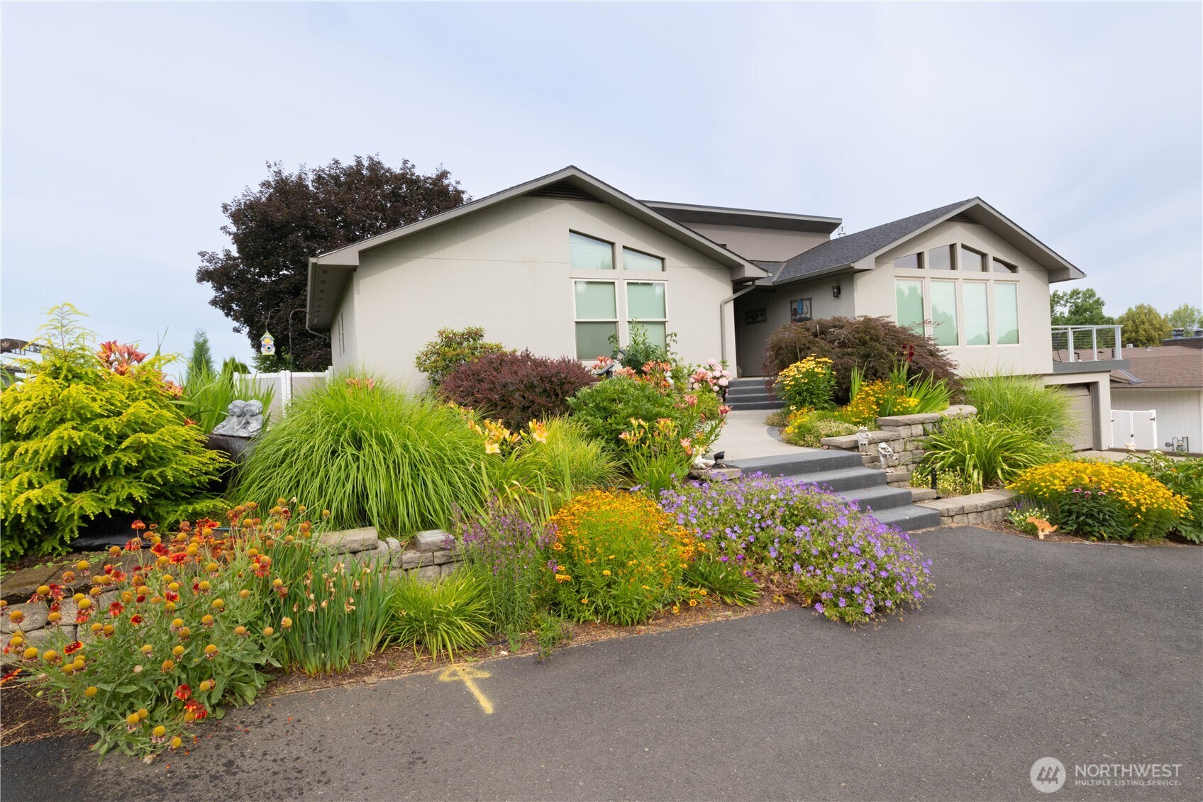 a front view of a house with a yard and outdoor seating