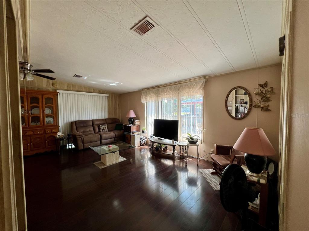 27 Robin Road Wildwood, FL 34785 - Photo 2 of 16 a living room with furniture window and a flat screen tv