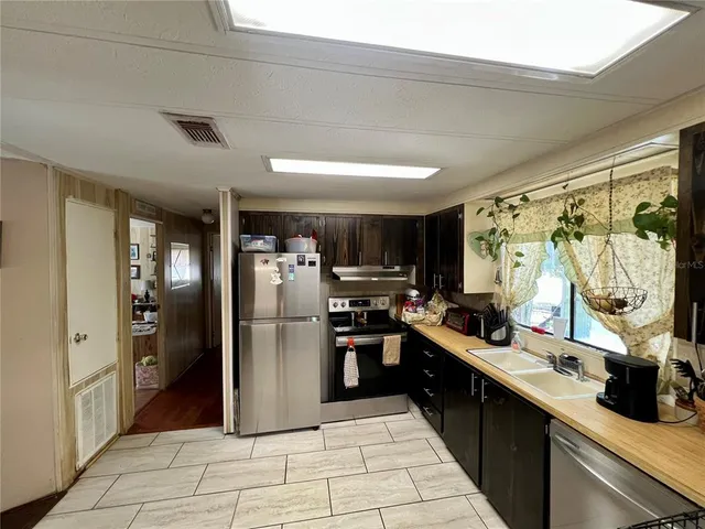 a kitchen with refrigerator and cabinets