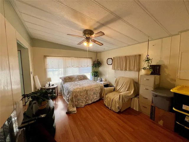 a bedroom with two beds and a chandelier