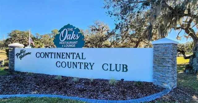 a sign that is next to a brick wall