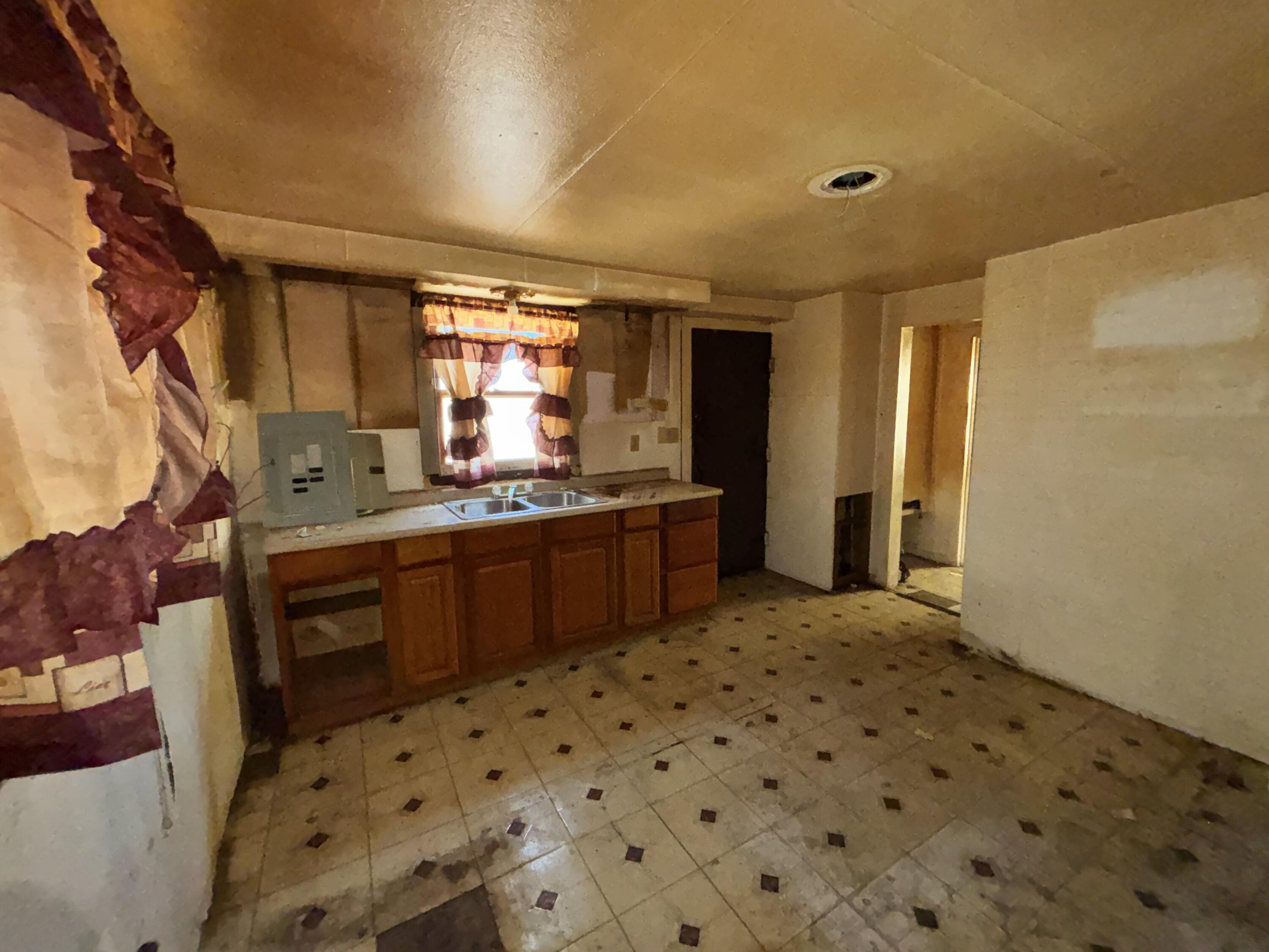 2407 Hanley Street Gary, IN 46406 - Photo 4 of 12 a kitchen with a sink a stove cabinets and a dining table