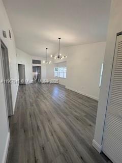 1141 Southwest 111th Way Davie, FL 33324 - Photo 2 of 19 wooden floor in an empty room with a window
