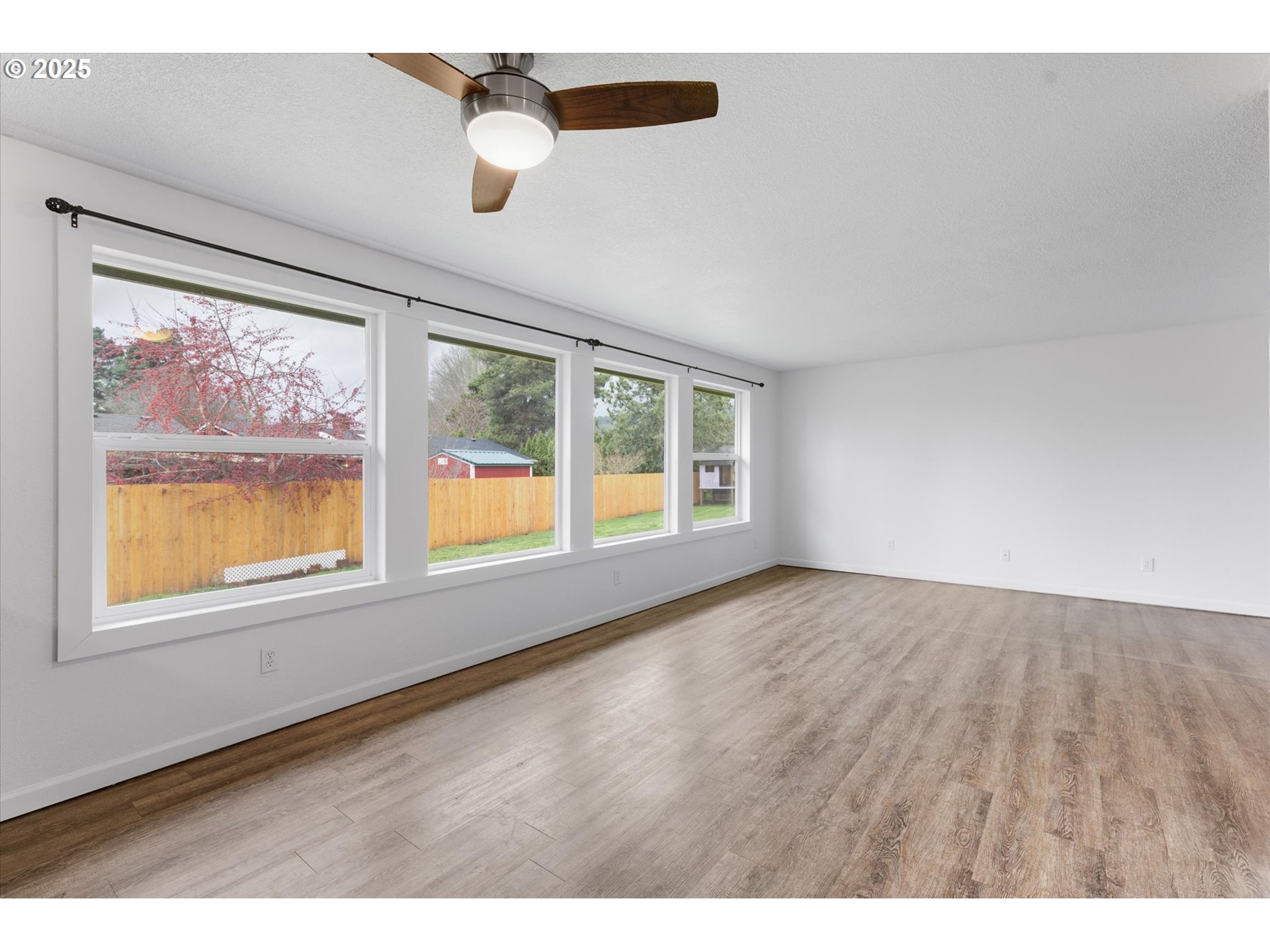 9 Lee Place Longview, WA 98632 - Photo 14 of 46 an empty room with wooden floor and windows