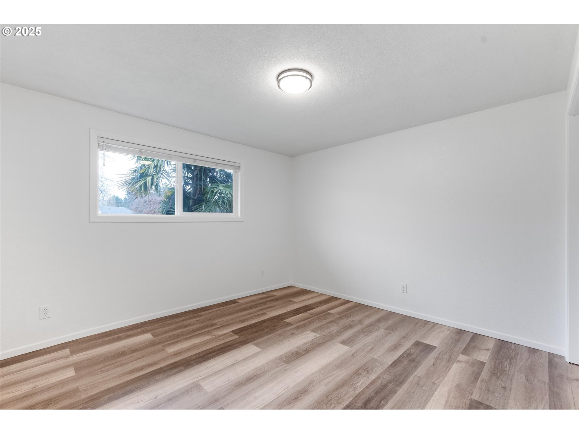 9 Lee Place Longview, WA 98632 - Photo 18 of 46 a view of an empty room with wooden floor and a window