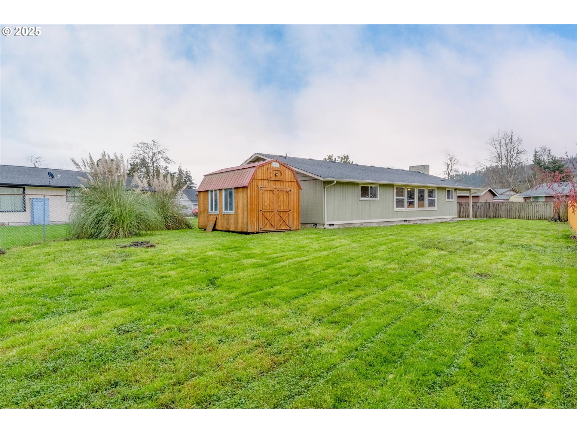 9 Lee Place Longview, WA 98632 - Photo 37 of 46 a view of a house with a big yard and large trees