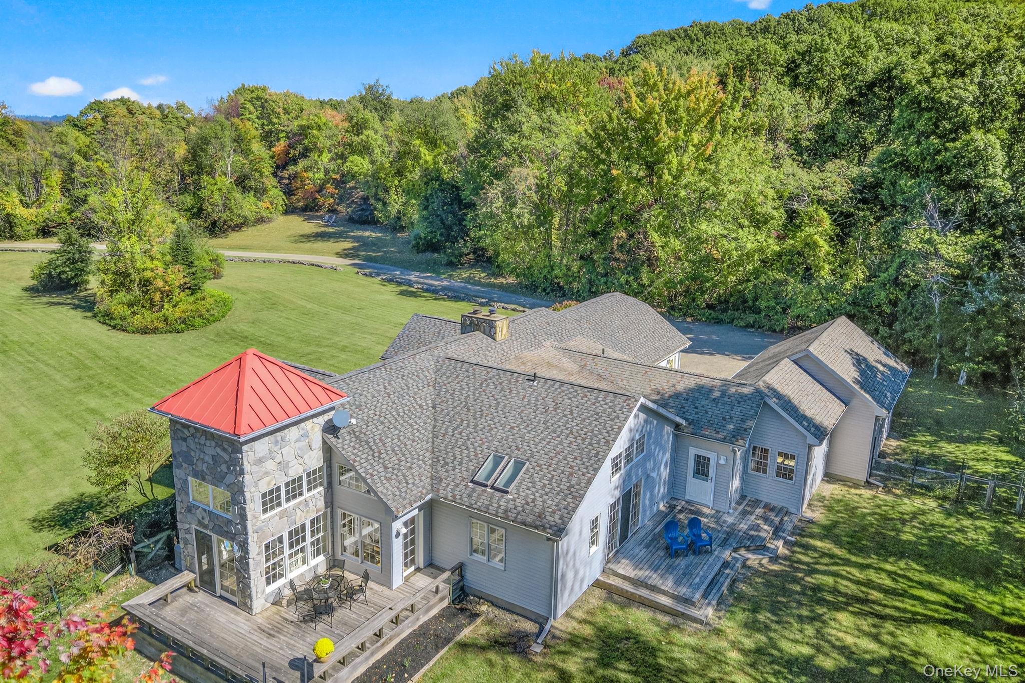 an aerial view of residential houses with outdoor space and trees