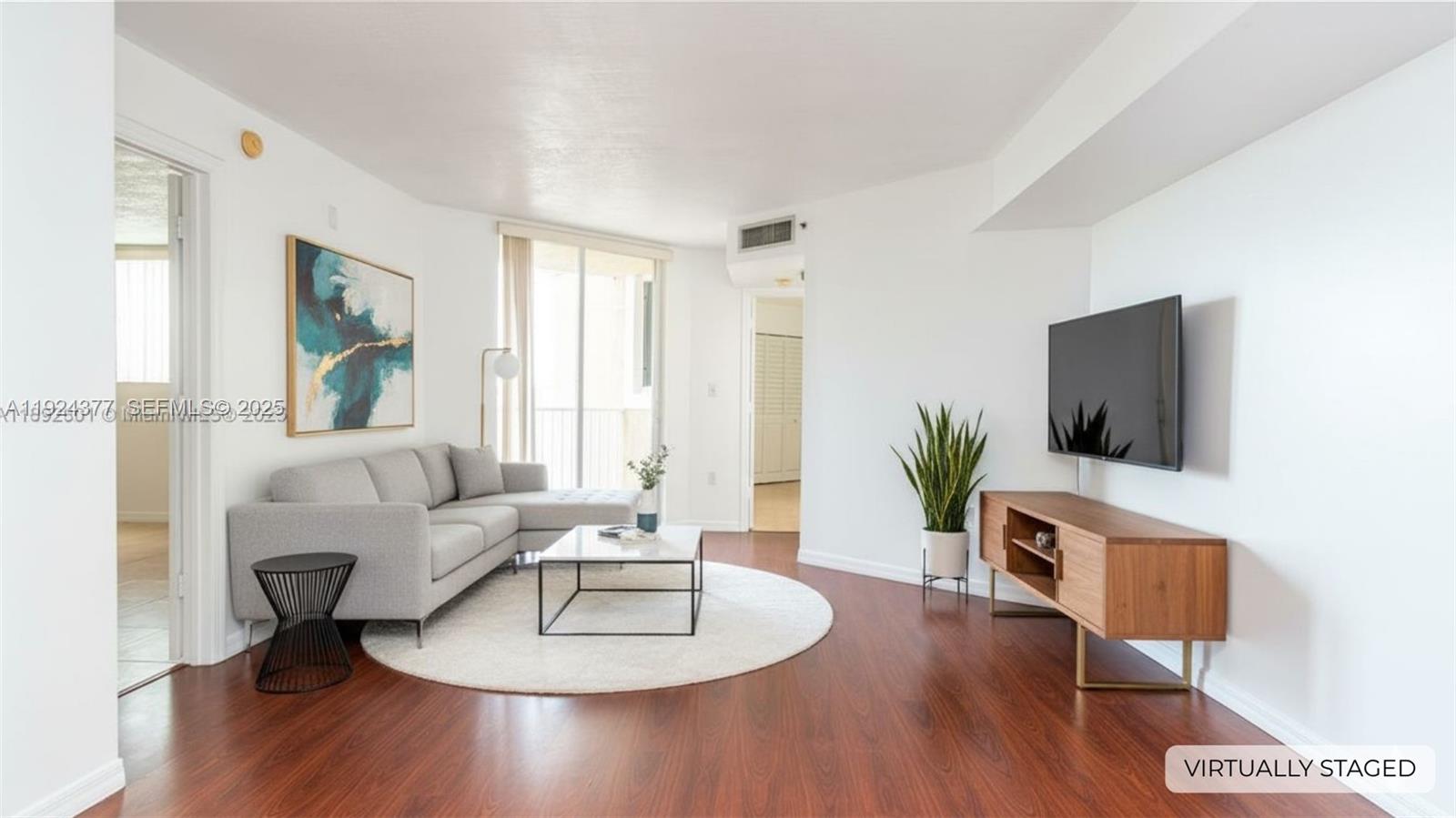 102 Southwest 6th Avenue, Unit 401 Miami, FL 33130 - Photo 2 of 15 a living room with furniture and a flat screen tv