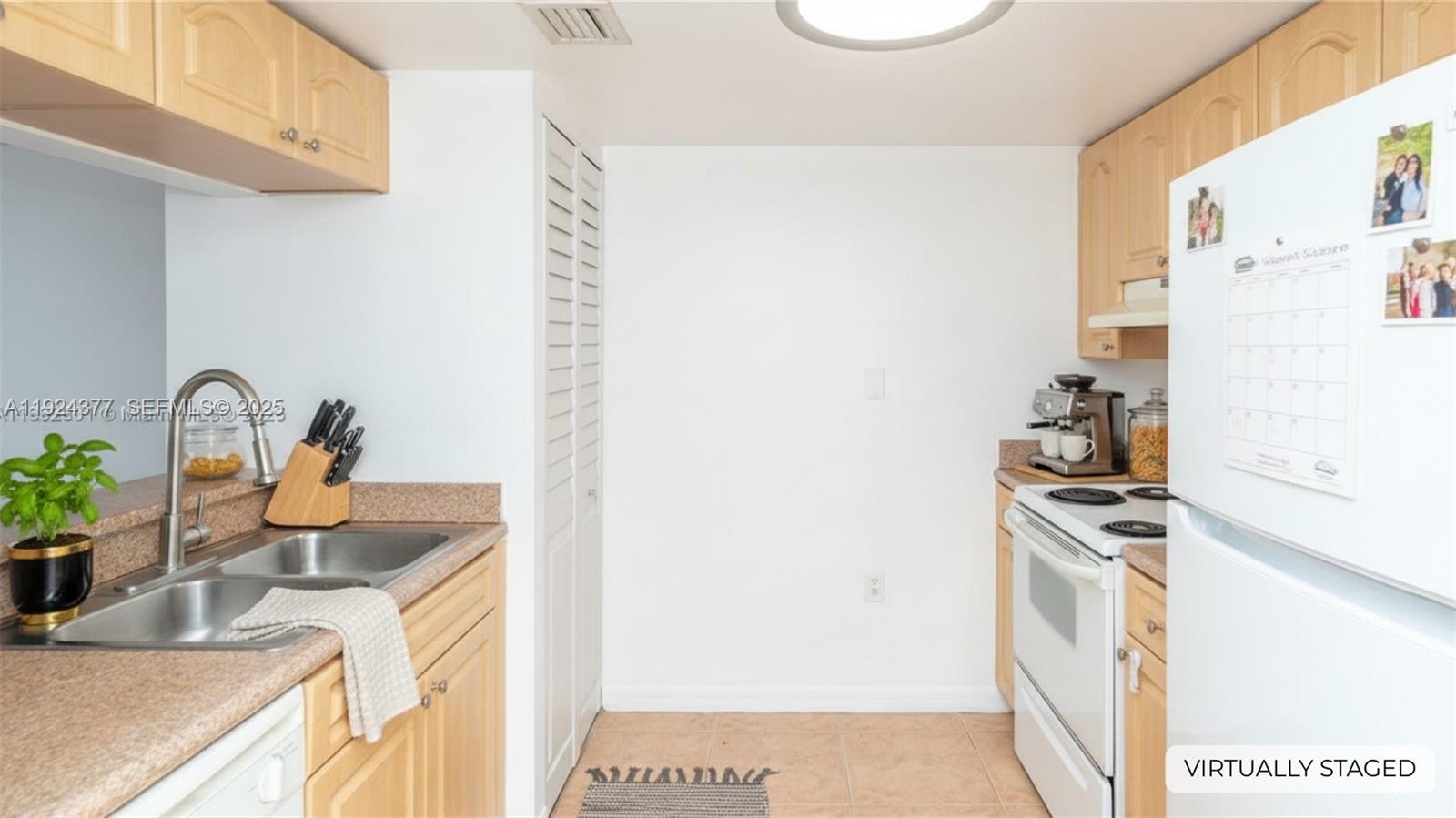 102 Southwest 6th Avenue, Unit 401 Miami, FL 33130 - Photo 4 of 15 a kitchen with stainless steel appliances granite countertop a sink and a stove