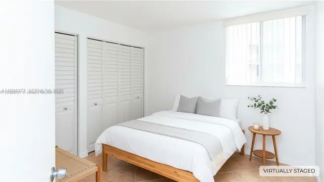 a bedroom with a bed and a potted plant