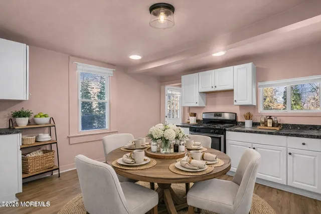 a view of a dining room with furniture and wooden floor