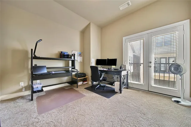 a view of a livingroom with workspace and a window