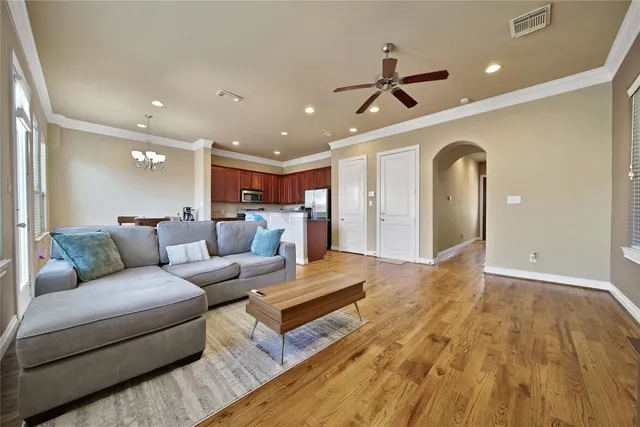 a living room with furniture and a ceiling fan